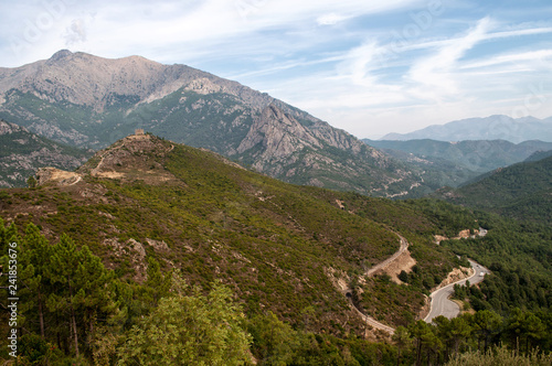 A creepy road leading through the mountainous landscape on the island of Corsica