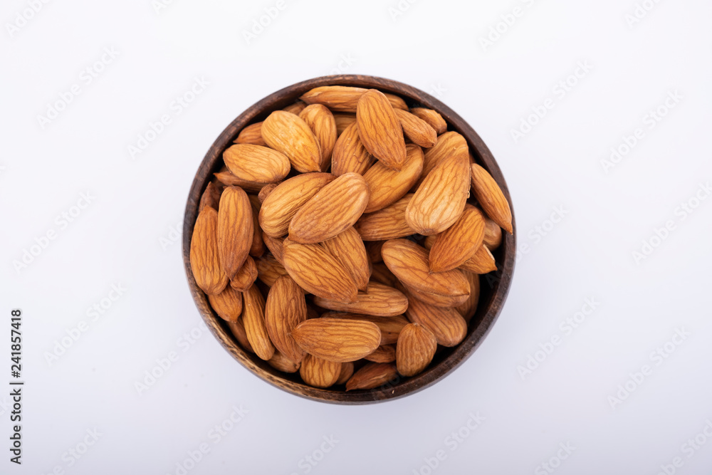 Almonds in a bowl and isolated on white Almonds in a bowl and isolated on white