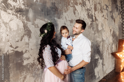 Pretty family with small son in the photo studio