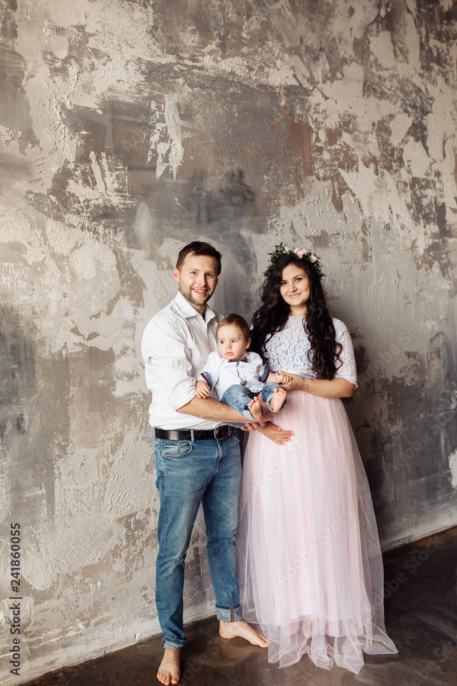 Pretty family with small son in the photo studio