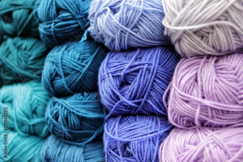 Colored skeins of yarn arranged in beautiful rows. Colors blue, cold. Yarn for knitting. wool, acryl.
