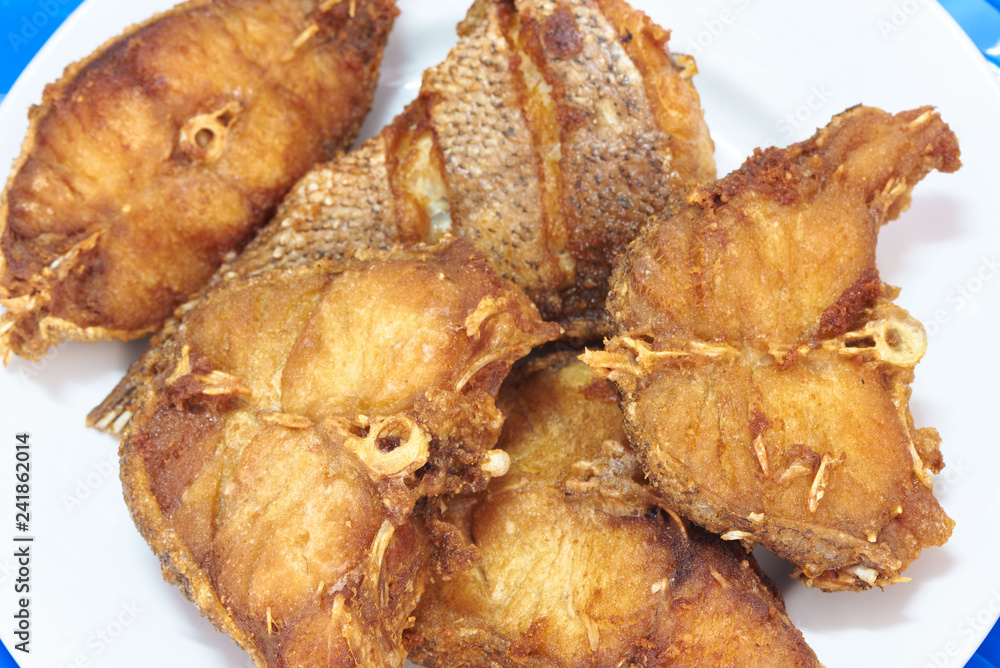 Many pieces of delicious fried grouper fish on a white dish Many pieces of delicious fried grouper fish on a white dish