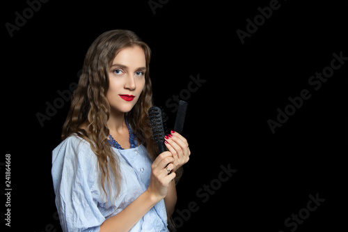 Beautiful girl holding black combs