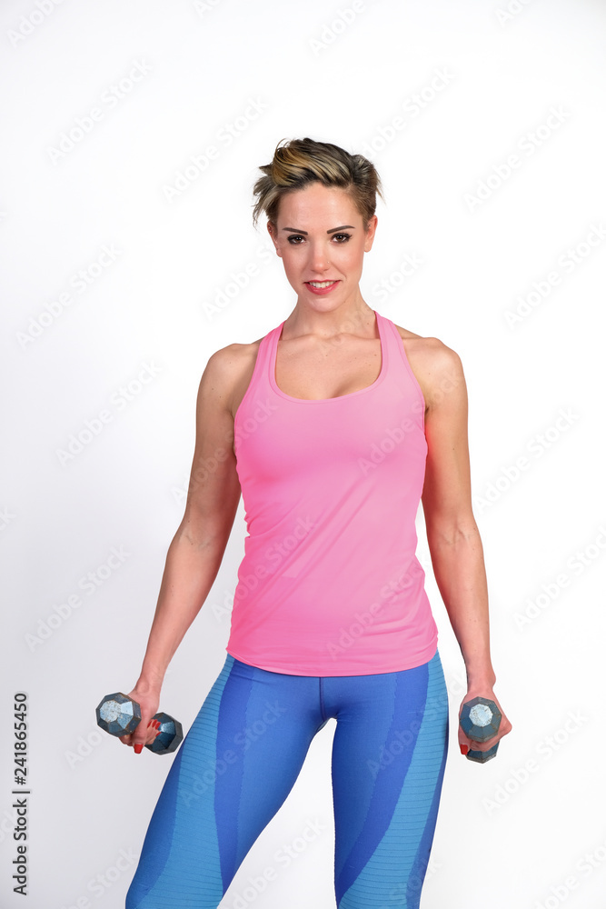 Beautiful and sporty young woman lifting up weights against white background. Beautiful and sporty young woman lifting up weights against white background.