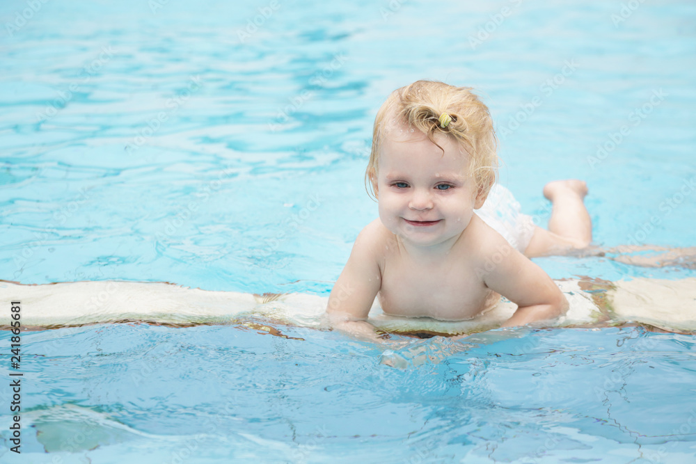 Portrait of a happy baby girl in the swimming pool Portrait of a happy baby girl in the swimming pool