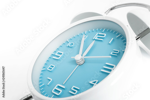 Table alarm clock with time 5 to 12 with blue clock face, 11.55 AM PM, on white background