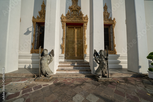 Chinese guardian figure beside a gate in Wat Pho photo