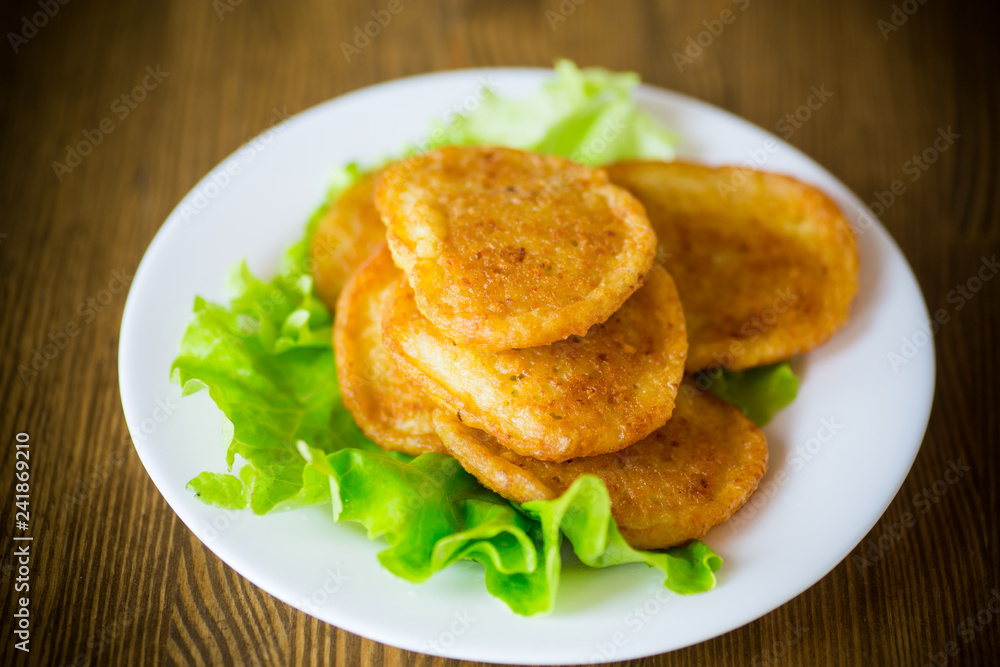 potato pancakes with lettuce leaves in a plate potato pancakes with lettuce leaves in a plate