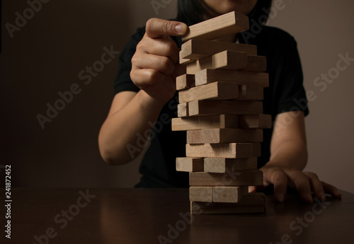 Property and business insurance protection concept. Insurance agent complete wooden model with last piece