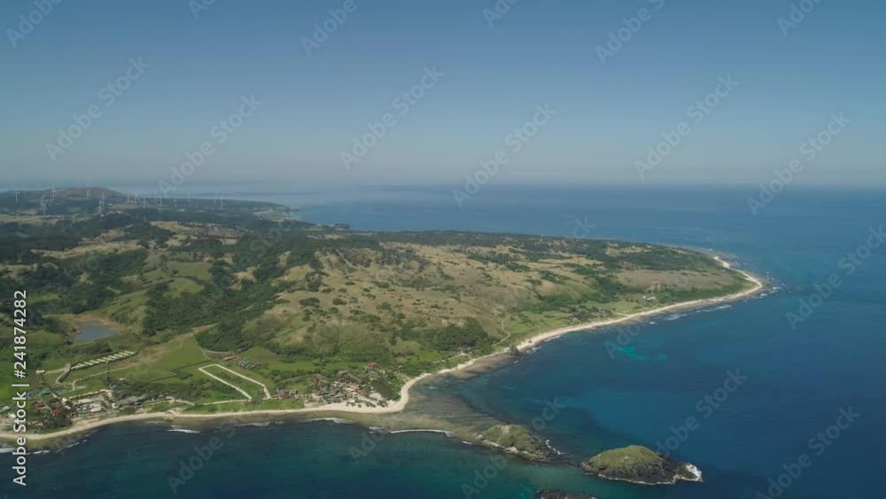 Aerial view beautiful tropical beach with turquoise water in blue lagoon, Pagudpud, Philippines. Ocean coastline with sandy beach. Tropical landscape in Asia. Aerial view beautiful tropical beach with turquoise water in blue lagoon, Pagudpud, Philippines. Ocean coastline with sandy beach. Tropical landscape in Asia.