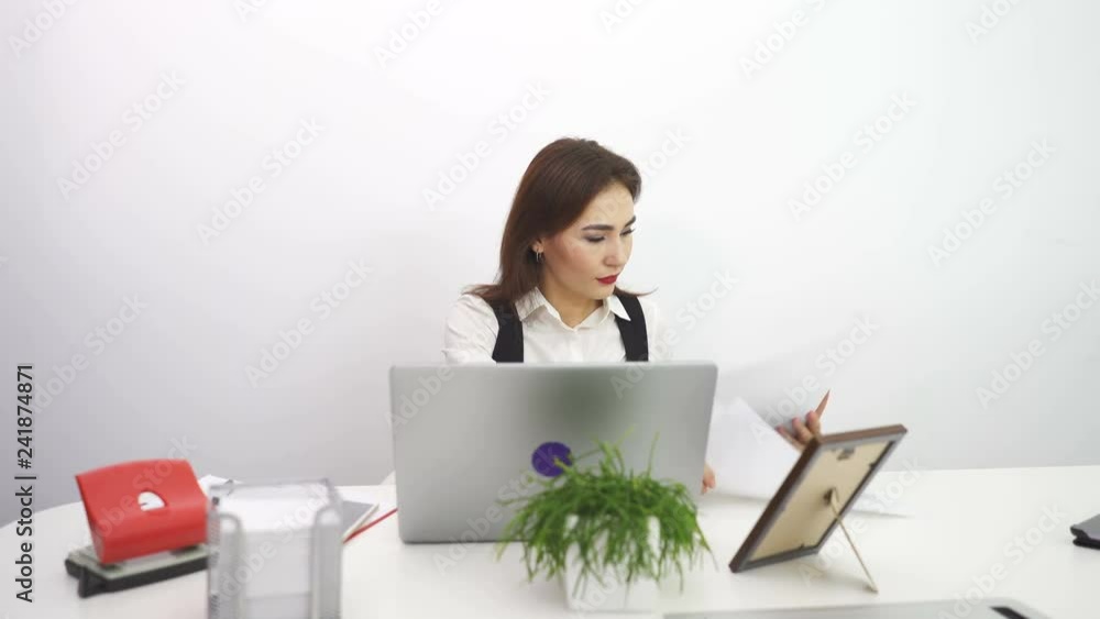 4К. Asian pretty business woman work at notebook in office. Dolly shot 4К. Asian pretty business woman work at notebook in office. Dolly shot