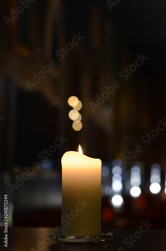 one candle with beautiful bokeh and blurry light reflections