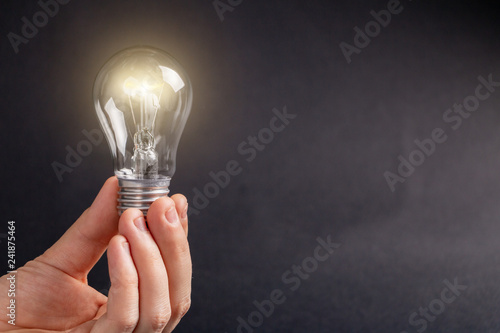Light bulb in hand lit.