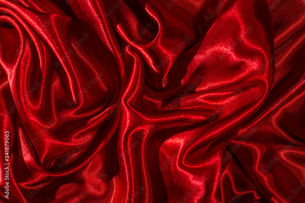 Satin fabric. Shiny red silk backdrop. Stock Photo