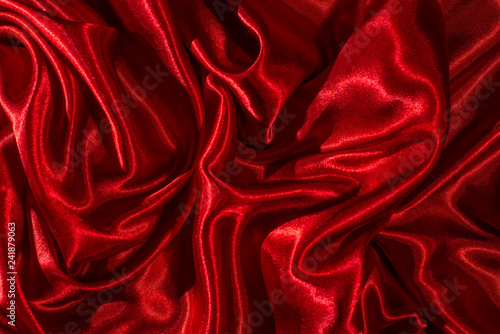 Satin fabric. Shiny red silk backdrop.