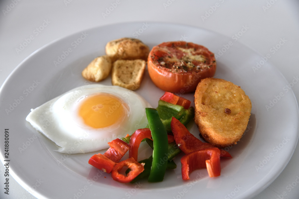Breakfast with scrambled eggs, fried buns and vegetables Breakfast with scrambled eggs, fried buns and vegetables