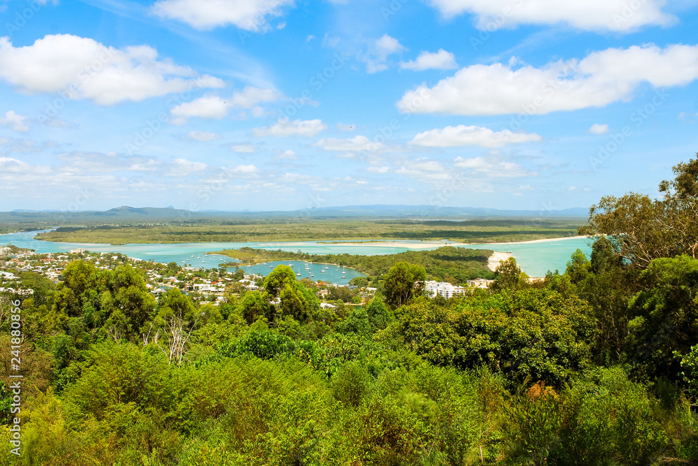 View of Noosa Heads and its clear sandy bay from Laguna Lookout on a sunny summer day near Noosa National Park (Queensland, Australia)