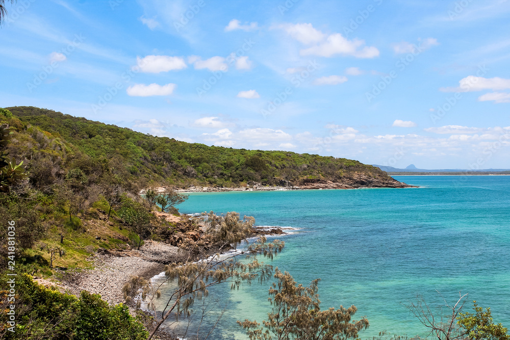 Spectacular view of Noosa National Park and its coastline with blue water, rocks and green forest during a clear summer day (Noosa Heads, Australia) Spectacular view of Noosa National Park and its coastline with blue water, rocks and green forest during a clear summer day (Noosa Heads, Australia)