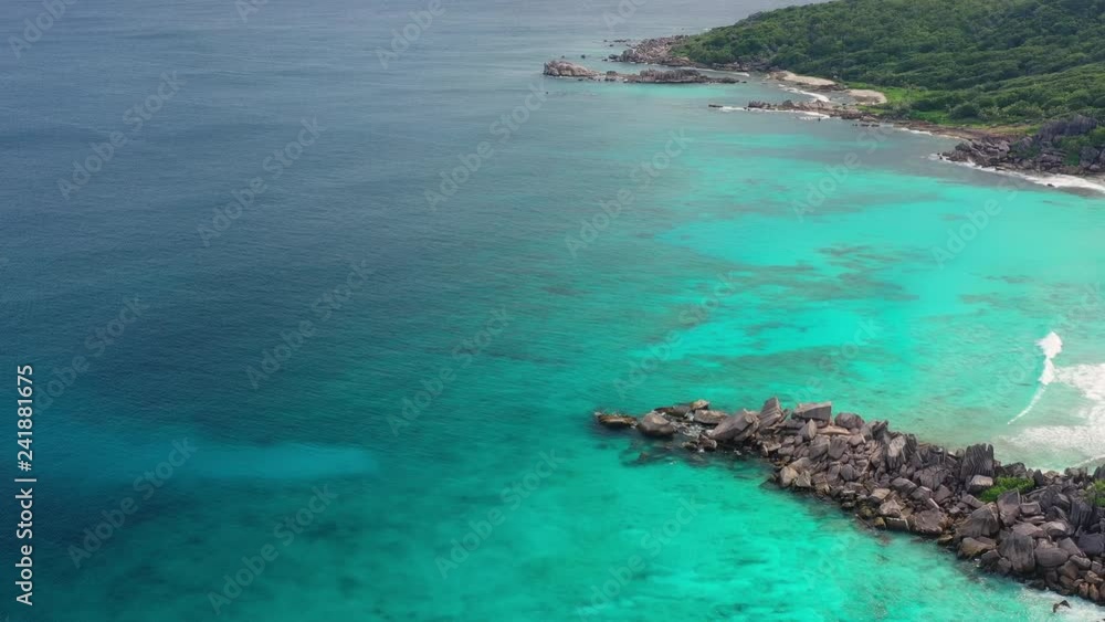 Aerial view of tropical paradise beach with white sand and turquoise crystal clear water of Indian Ocean - Grand Anse, La Digue Island, Seychelles Islands Aerial view of tropical paradise beach with white sand and turquoise crystal clear water of Indian Ocean - Grand Anse, La Digue Island, Seychelles Islands