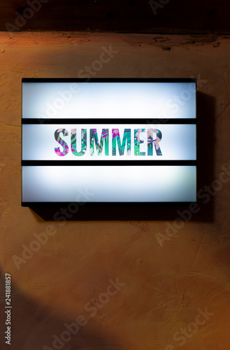 Summer text on illuminated background.