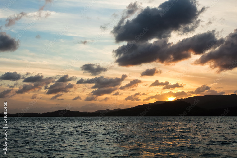 Sunset over Whitsunday Islands as seen during a yacht cruise in the evening (Whitsunday Islands, Queensland, Australia)