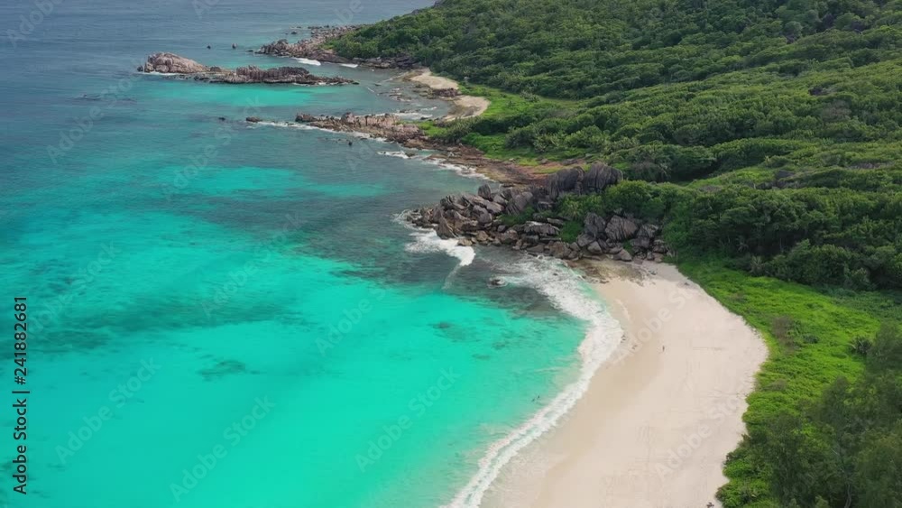 Aerial view of tropical paradise beach with white sand and turquoise crystal clear water of Indian Ocean - Grand Anse, La Digue Island, Seychelles Islands Aerial view of tropical paradise beach with white sand and turquoise crystal clear water of Indian Ocean - Grand Anse, La Digue Island, Seychelles Islands