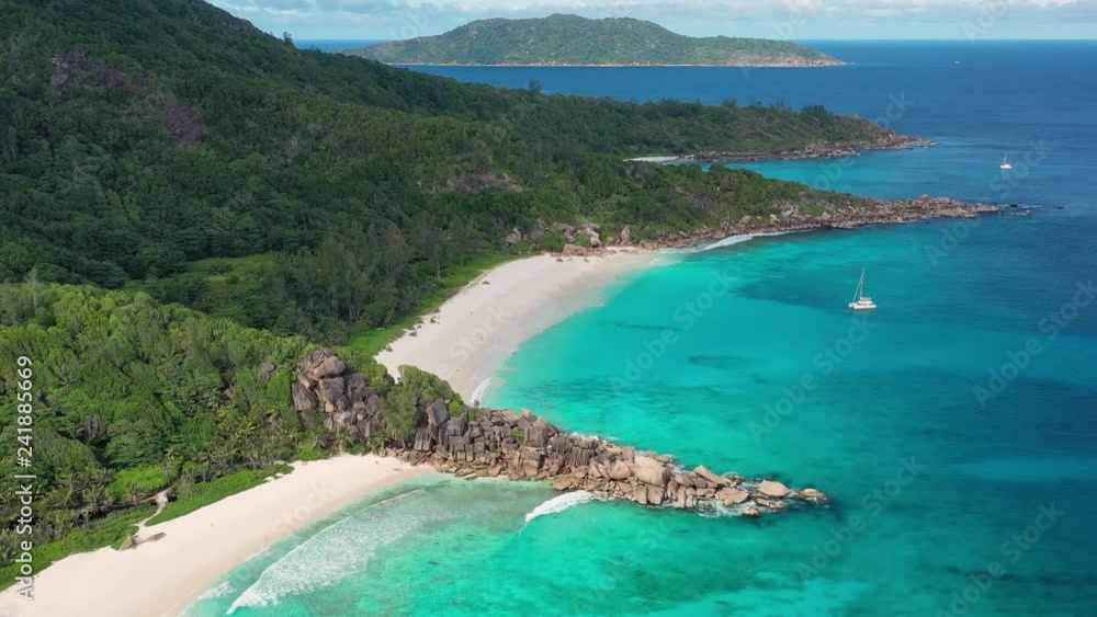 Aerial view of tropical paradise beaches with white sand and turquoise crystal clear water of Indian Ocean - Grand Anse and Petite Anse, La Digue Island, Seychelles Islands Aerial view of tropical paradise beaches with white sand and turquoise crystal clear water of Indian Ocean - Grand Anse and Petite Anse, La Digue Island, Seychelles Islands