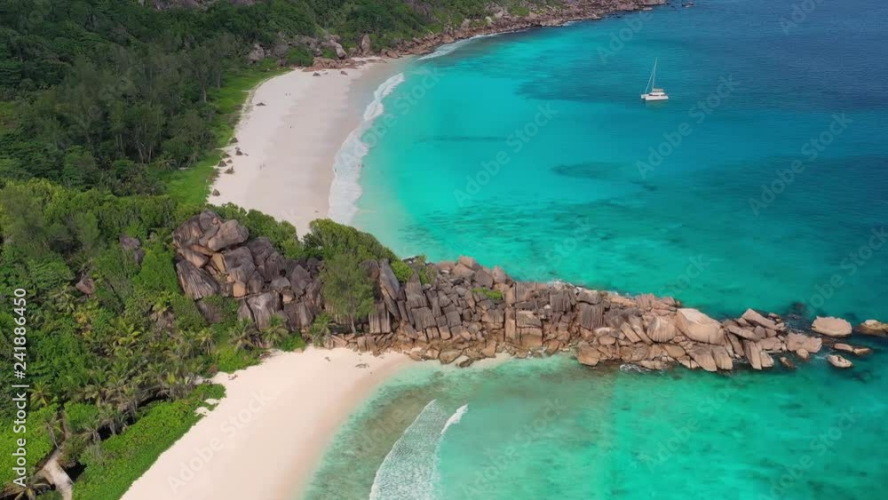 Aerial view of tropical paradise beaches with white sand and turquoise crystal clear water of Indian Ocean - Grand Anse and Petite Anse, La Digue Island, Seychelles Islands Aerial view of tropical paradise beaches with white sand and turquoise crystal clear water of Indian Ocean - Grand Anse and Petite Anse, La Digue Island, Seychelles Islands