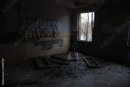 Urbex  scary abandoned and dark room with pile of broken windows 
