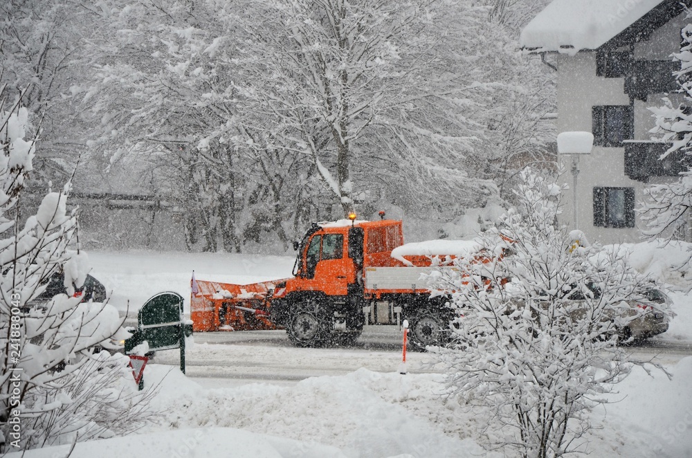 snowplow on the road in winter time snowplow on the road in winter time