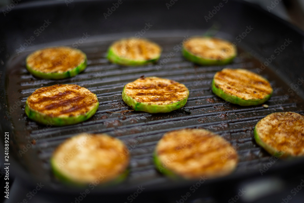 grilled zucchini with powdered paprika in a grill pan grilled zucchini with powdered paprika in a grill pan
