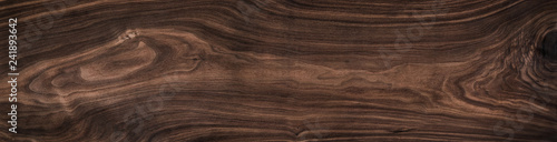 Super long walnut planks texture background.Dark tone walnut texture,Walnut natural texture.