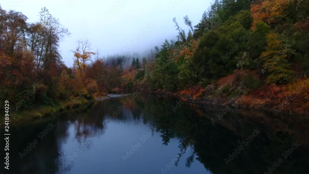 Calm reflective river in the early morning fog. Calm reflective river in the early morning fog.