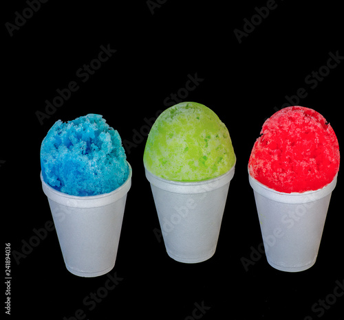 Photography Red, green and blue Hawaiian shaved ice, shave ice or snow cone servings on a black background