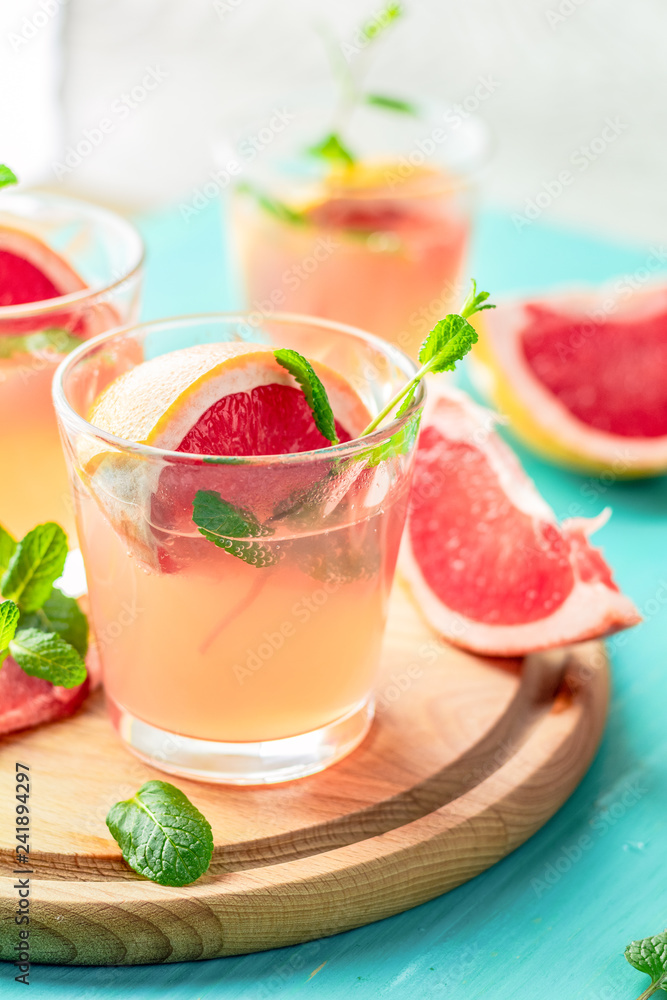 Pink alcoholic cocktail with grapefruit, ice and min Pink alcoholic cocktail with grapefruit, ice and min