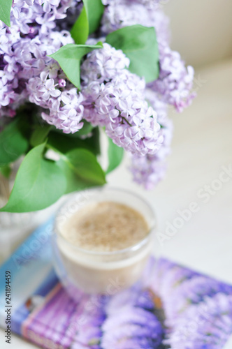 cup of coffee and lilac flowers