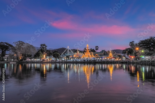 Lake view evening of Wat Chong Klang and Wat Chong Kham Chedi Myanmar style art with reflection on the surface of water and colorful twilight vivid sky background, Mae Hong Son, northern of Thailand.