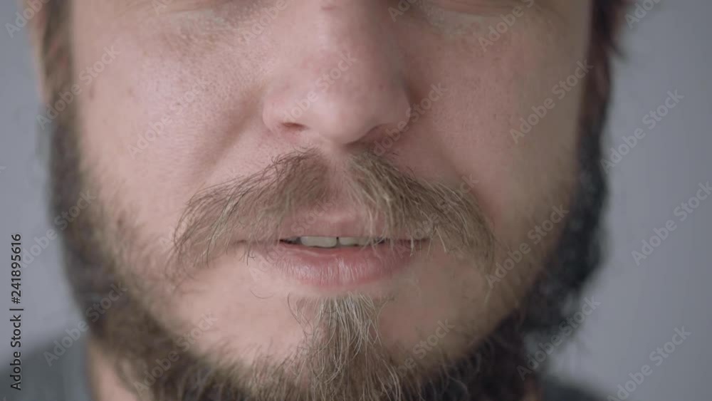 Close up view of Male Lips, Saying - I Love You. Macro closeup of lower half of Male Face with Mustache - Bearded Man Mouth which Smiling and making Kissing Faces - in low motion. Close up view of Male Lips, Saying - I Love You. Macro closeup of lower half of Male Face with Mustache - Bearded Man Mouth which Smiling and making Kissing Faces - in low motion.