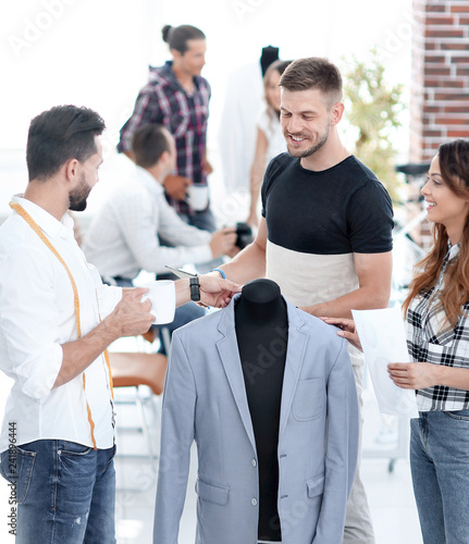 group of designers discuss men's suit