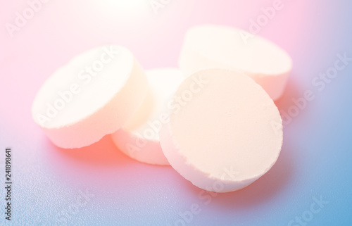 Big pills close up over blue background