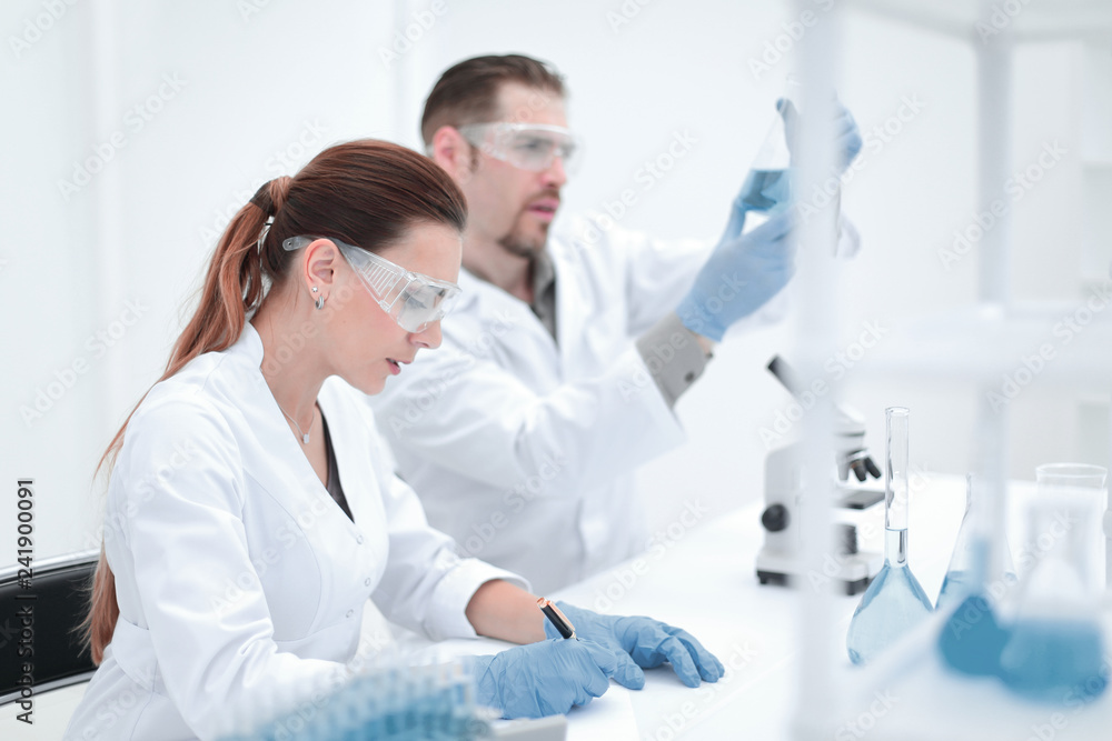 two scientists work in the laboratory. two scientists work in the laboratory.