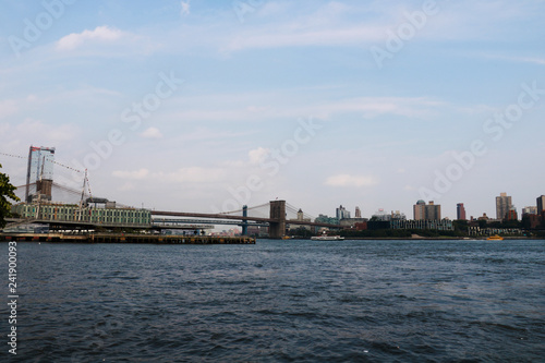 New York, USA - September 2, 2018: Brooklyn Bridge with the skyline of Downtown Manhattan on cloudy sky. © Dzmitry
