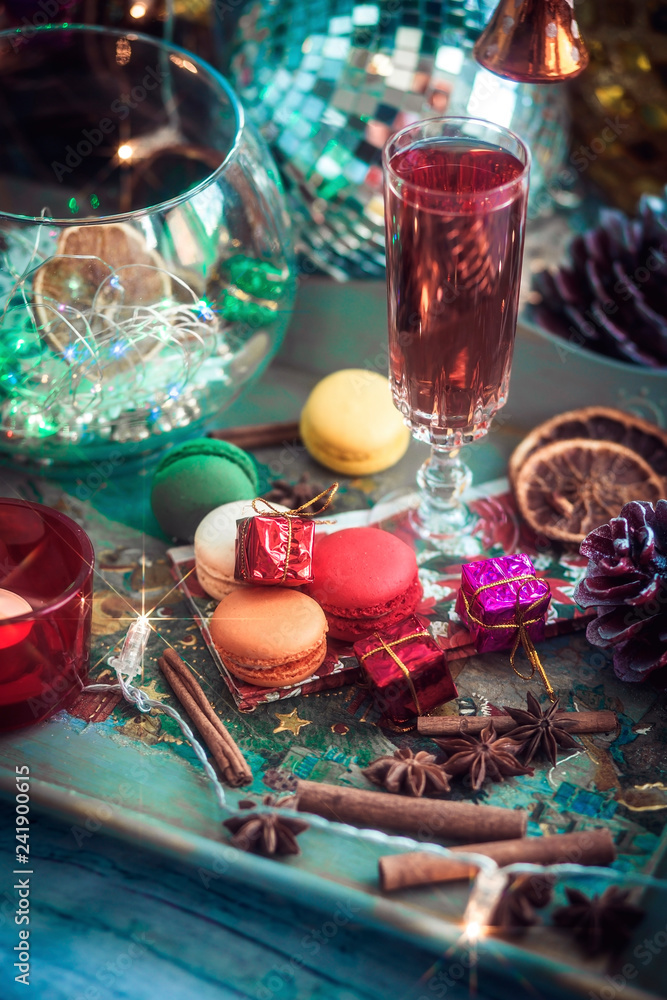 Christmas still life with glass of wine and macaroons