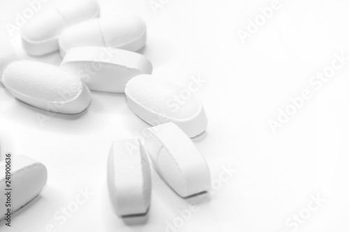 white medical pills, on white background, close-up