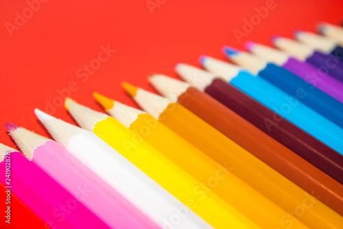 School supplies  colored pencils in a row  isolated  closeup