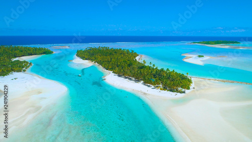AERIAL  Spectacular view of lush exotic island and boats anchored in the ocean.