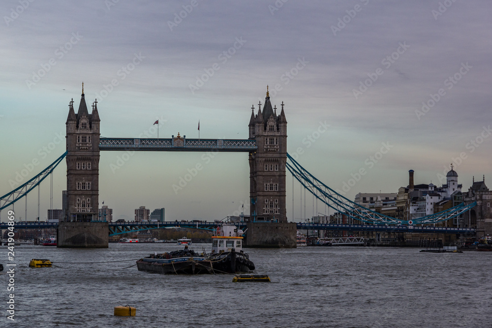 Landscape view of Tower bridge on the river Thames. Some ships sailing on the river. London, United Kingdom.