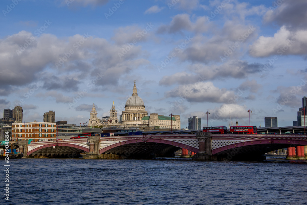 Landscape view of Southwark Bridge on the river Thames and business modern district with many skyscrapers in the background. London, United Kingdom.
