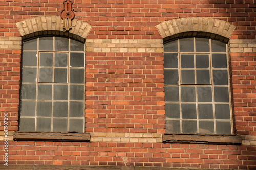Old empty brick house factory with dark windows