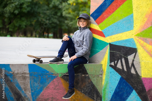 Skater girl on skatepark moving on skateboard outdoors. Copy space